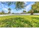Spacious backyard with green grass and a white vinyl fence for privacy at 4509 Wynkoop Cir, Port Charlotte, FL 33948
