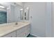 Bathroom featuring blue tiles, large vanity, and ample storage at 4509 Wynkoop Cir, Port Charlotte, FL 33948
