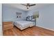 Bedroom featuring wood floors, ceiling fan, bed, dresser and natural light at 4509 Wynkoop Cir, Port Charlotte, FL 33948