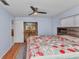 Bedroom features a ceiling fan, hardwood floors and sliding glass doors at 4509 Wynkoop Cir, Port Charlotte, FL 33948