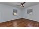 Bedroom with hardwood floors, ceiling fan and natural light from two windows at 4509 Wynkoop Cir, Port Charlotte, FL 33948