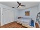Bedroom with hardwood floors, a ceiling fan, and closet with louvered doors at 4509 Wynkoop Cir, Port Charlotte, FL 33948