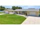 Charming single-story home with a well-maintained lawn and a detached two-car garage at 4509 Wynkoop Cir, Port Charlotte, FL 33948