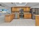 Well-equipped kitchen with stainless steel appliances and beautiful wooden cabinetry at 4509 Wynkoop Cir, Port Charlotte, FL 33948