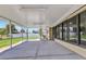 Large screened in porch featuring windows into the main house and a view of the backyard at 4509 Wynkoop Cir, Port Charlotte, FL 33948