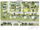 Aerial view of residential properties in a neighborhood featuring well-maintained lawns at 500 Winwood Ct, Port Charlotte, FL 33954