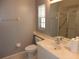Bathroom featuring a single vanity, standard toilet, tiled floors, and shower over bath combo with glass shower doors at 500 Winwood Ct, Port Charlotte, FL 33954