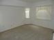Empty bedroom featuring neutral carpet, and a standard light fixture and natural light through the standard windows at 500 Winwood Ct, Port Charlotte, FL 33954