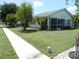 Single-story home with lush lawn and mature trees providing shade and curb appeal at 500 Winwood Ct, Port Charlotte, FL 33954