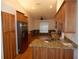 Modern kitchen showcasing stainless steel appliances, granite countertops, and custom cabinetry with open floor plan at 500 Winwood Ct, Port Charlotte, FL 33954