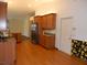 Open-concept kitchen with wood cabinets, granite countertops, stainless appliances, and tile flooring adjacent to the living area at 500 Winwood Ct, Port Charlotte, FL 33954
