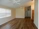 Spacious living room featuring wood floors, neutral paint, bright light through the window and dual ceiling fans at 500 Winwood Ct, Port Charlotte, FL 33954