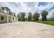 Home featuring a spacious partially cleared backyard with mature trees at 5018 Cillette Ave, North Port, FL 34288