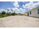 Large partially cleared backyard with lush foliage surrounding the property at 5018 Cillette Ave, North Port, FL 34288