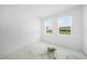 Bright bedroom featuring two windows that offer backyard views and natural light at 5018 Cillette Ave, North Port, FL 34288