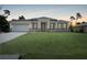 Charming single-story home featuring a well-manicured lawn, a two-car garage, and a welcoming entrance at 5018 Cillette Ave, North Port, FL 34288