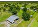 Aerial showcasing property with barn, spacious grounds, mature trees and long driveway at 5221 Blackjack Cir, Punta Gorda, FL 33982