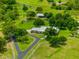 Stunning aerial view of the property, showcasing the home, sprawling lawns, mature trees, and winding driveway at 5221 Blackjack Cir, Punta Gorda, FL 33982