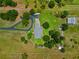 Birds-eye view of the property, highlighting its spacious lot, well-maintained home, and surrounding greenery at 5221 Blackjack Cir, Punta Gorda, FL 33982