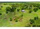 Panoramic aerial view showing the property's size with mature trees, and a peaceful pond at 5221 Blackjack Cir, Punta Gorda, FL 33982