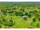 Expansive aerial view capturing the property's generous acreage, complemented by lush landscaping and outbuildings at 5221 Blackjack Cir, Punta Gorda, FL 33982