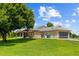 Beautiful backyard with a metal roof home, a screened lanai, a pergola with outdoor seating, and an attached garage at 5221 Blackjack Cir, Punta Gorda, FL 33982