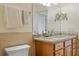 Bathroom featuring a granite countertop, a toilet, and a large mirror at 5221 Blackjack Cir, Punta Gorda, FL 33982