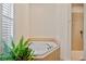 Bright bathroom featuring a garden tub and a walk-in shower at 5221 Blackjack Cir, Punta Gorda, FL 33982