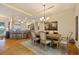 Elegant dining room featuring a chandelier, neutral colors, and an adjacent breakfast bar at 5221 Blackjack Cir, Punta Gorda, FL 33982