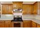 Kitchen featuring stainless steel appliances, wooden cabinets, and granite countertops at 5221 Blackjack Cir, Punta Gorda, FL 33982