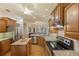 Kitchen with wooden cabinetry, granite countertops, and a stainless steel refrigerator at 5221 Blackjack Cir, Punta Gorda, FL 33982