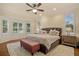 Bright main bedroom featuring a tufted headboard, lots of natural light and ceiling fan at 5221 Blackjack Cir, Punta Gorda, FL 33982