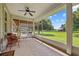 Relaxing screened porch with ceiling fan, offering panoramic views of the beautiful outdoor space and greenery at 5221 Blackjack Cir, Punta Gorda, FL 33982