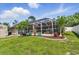 Spacious backyard with a screened-in pool, lush landscaping, and a storage shed at 5273 Crestline Ter, Port Charlotte, FL 33981