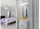 Connected bedroom and bath area with marble-topped vanity and full mirror at 5273 Crestline Ter, Port Charlotte, FL 33981