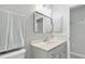 Bathroom featuring modern vanity, toilet, and mirror; decorated in relaxing light grey tones at 5273 Crestline Ter, Port Charlotte, FL 33981