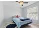 Cozy bedroom featuring a ceiling fan, plush bed, and natural light from the window at 5273 Crestline Ter, Port Charlotte, FL 33981