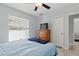 Comfortable bedroom with light hardwood floors, large window, ceiling fan, and a dresser at 5273 Crestline Ter, Port Charlotte, FL 33981