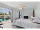 Bright bedroom with ceiling fan, slider access to screened-in pool area at 5273 Crestline Ter, Port Charlotte, FL 33981