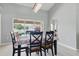 Dining room area featuring contemporary chandelier lighting and views of the pool at 5273 Crestline Ter, Port Charlotte, FL 33981