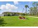 Sprawling green lawn in front of this single-story home with solar panels at 5273 Crestline Ter, Port Charlotte, FL 33981