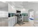 A kitchen with stainless steel appliances, white and light blue cabinets, and ample counter space at 5273 Crestline Ter, Port Charlotte, FL 33981