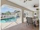 Covered outdoor dining area with a view of the pool in a screened enclosure at 5273 Crestline Ter, Port Charlotte, FL 33981