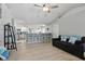 Living room area featuring wood floors and a kitchen bar that looks into the kitchen at 5273 Crestline Ter, Port Charlotte, FL 33981
