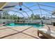 Inviting screened-in pool area with lounge chairs and lush greenery at 5273 Crestline Ter, Port Charlotte, FL 33981