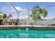 Relaxing pool area surrounded by lush landscaping and a screened enclosure at 5273 Crestline Ter, Port Charlotte, FL 33981