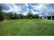 Expansive backyard featuring a lush lawn and mature trees, perfect for outdoor activities at 591 San Ambrosio St, Punta Gorda, FL 33983