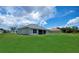 Spacious backyard featuring lush green grass and a screened patio at 591 San Ambrosio St, Punta Gorda, FL 33983