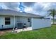 View of the home's exterior, back door, and small fenced area on a well-maintained lot at 591 San Ambrosio St, Punta Gorda, FL 33983