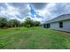 Expansive backyard featuring lush green grass and a screened patio at 591 San Ambrosio St, Punta Gorda, FL 33983